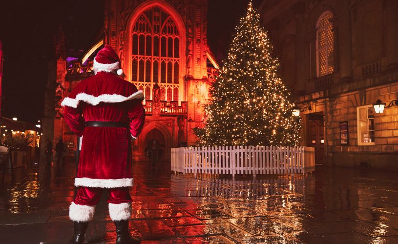 Father Christmas ourside Bath Abbey at night